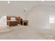 Open-concept living room featuring a vaulted ceiling, fireplace, and neutral carpet at 441 Vermilion Dr, York, SC 29745