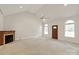 Spacious living room featuring a vaulted ceiling, fireplace, and arched windows at 441 Vermilion Dr, York, SC 29745
