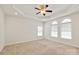 Bright main bedroom featuring a tray ceiling, arched windows, and neutral carpet at 441 Vermilion Dr, York, SC 29745