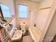Neat bathroom featuring a window, a shower-tub combo, and a classic sink at 450 1St Se St, Hickory, NC 28602