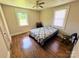 Cozy bedroom with hardwood floors, two windows, and a ceiling fan at 450 1St Se St, Hickory, NC 28602