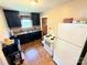 Functional kitchen featuring dark cabinetry, wood floors, and white appliances at 450 1St Se St, Hickory, NC 28602