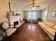 Spacious living room featuring a brick fireplace, windows, and hardwood floors at 450 1St Se St, Hickory, NC 28602