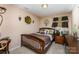 Cozy bedroom featuring neutral walls, wood furniture, and soft lighting at 611 Sawtooth Oak Dr, Landis, NC 28088