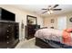 Neutral bedroom with a ceiling fan, a dark dresser, and a comfortable bed at 611 Sawtooth Oak Dr, Landis, NC 28088