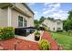 Relaxing patio with comfortable seating, barbecue grill, and landscaped yard at 611 Sawtooth Oak Dr, Landis, NC 28088