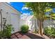 Private backyard featuring a white fence, greenery, and an outbuilding for extra storage or workshop space at 6128 Warrior Ave, Fort Mill, SC 29707