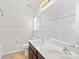 Bright bathroom featuring a double sink vanity, large mirror, and a shower-tub combo at 6128 Warrior Ave, Fort Mill, SC 29707