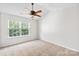 Spacious bedroom with a ceiling fan and a window overlooking the yard at 6128 Warrior Ave, Fort Mill, SC 29707
