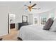 Comfortable bedroom featuring a ceiling fan, dresser, and a view to an en-suite bathroom at 6128 Warrior Ave, Fort Mill, SC 29707