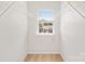 Walk-in closet featuring white wire shelving and a window for natural light at 6128 Warrior Ave, Fort Mill, SC 29707