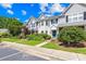 Attractive townhomes showcasing beautiful landscaping and manicured lawns, adding to the neighborhood's charm at 6128 Warrior Ave, Fort Mill, SC 29707