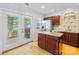 Well-appointed kitchen featuring stainless steel appliances, granite countertops, and a view to the backyard at 6128 Warrior Ave, Fort Mill, SC 29707