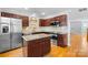 Well-lit kitchen featuring stainless steel appliances, granite countertops, and a kitchen island at 6128 Warrior Ave, Fort Mill, SC 29707