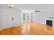 Bright living room with hardwood floors, fireplace, and lots of natural light from bay windows at 6128 Warrior Ave, Fort Mill, SC 29707
