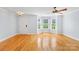 Inviting living space featuring gleaming hardwood floors, a ceiling fan, and plenty of natural light at 6128 Warrior Ave, Fort Mill, SC 29707