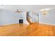 Inviting living space with hardwood floors, fireplace, staircase, and stylish chandelier at 6128 Warrior Ave, Fort Mill, SC 29707