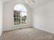 Bright bedroom featuring a large arched window, neutral carpet, and ceiling fan at 7006 Lone Eagle Dr # 18, Monroe, NC 28110