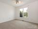 Bedroom showcasing carpet flooring, ceiling fan, and a large window at 7006 Lone Eagle Dr # 18, Monroe, NC 28110