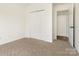 Bedroom with plush carpet, a closet, and view into the hallway at 7006 Lone Eagle Dr # 18, Monroe, NC 28110