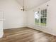 Sunlit dining area showcases wood-look floors and large windows with scenic outdoor views and a modern chandelier at 7006 Lone Eagle Dr # 18, Monroe, NC 28110