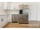 Well-lit kitchen features modern appliances, white cabinets, and new wood-look flooring at 7006 Lone Eagle Dr # 18, Monroe, NC 28110