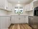 Updated kitchen with white cabinets, stainless steel appliances, and a window overlooking the backyard at 7006 Lone Eagle Dr # 18, Monroe, NC 28110