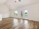 Open-concept living room with hardwood floors, vaulted ceilings, and lots of natural light at 7006 Lone Eagle Dr # 18, Monroe, NC 28110