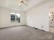 Main bedroom featuring carpet flooring, a tray ceiling, and natural light at 7006 Lone Eagle Dr # 18, Monroe, NC 28110