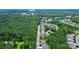 An aerial view of the property near a golf course surrounded by lush greenery in a residential neighborhood at 7011 Hyde Park Dr, Indian Trail, NC 28079
