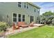 Spacious backyard featuring a brick patio, lush lawn, and mature landscaping at 7011 Hyde Park Dr, Indian Trail, NC 28079