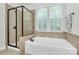 Bathroom featuring a separate shower and tub beneath a window at 7011 Hyde Park Dr, Indian Trail, NC 28079