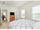 Inviting bedroom featuring soft carpet, windows, and a cozy bed with a patterned comforter and white pillows at 7011 Hyde Park Dr, Indian Trail, NC 28079