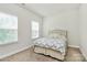 Well-lit bedroom with soft carpet, a plush bed, and natural light streaming through the windows creating a cozy atmosphere at 7011 Hyde Park Dr, Indian Trail, NC 28079