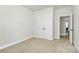 Bright bedroom featuring neutral walls, carpet, and a double door closet at 7011 Hyde Park Dr, Indian Trail, NC 28079