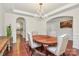 Formal dining area featuring hardwood floors, elegant chandelier, and wainscoting for sophisticated meals at 7011 Hyde Park Dr, Indian Trail, NC 28079