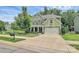 Well-maintained home boasts a manicured lawn, two-car garage, and close proximity to green spaces at 7011 Hyde Park Dr, Indian Trail, NC 28079
