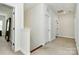 Hallway with neutral walls, carpet, and access to multiple rooms at 7011 Hyde Park Dr, Indian Trail, NC 28079