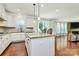Bright, open kitchen with granite counters, island seating, and stainless steel appliances overlooking an inviting living area at 7011 Hyde Park Dr, Indian Trail, NC 28079