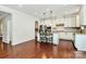 Spacious kitchen features stainless steel appliances, a center island with seating, and hardwood floors at 7011 Hyde Park Dr, Indian Trail, NC 28079