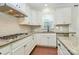 Bright kitchen equipped with white cabinets, granite countertops, and stainless steel appliances offers optimal functionality at 7011 Hyde Park Dr, Indian Trail, NC 28079