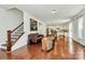 An open floor plan showcases hardwood floors, staircase, and a modern kitchen in this inviting living space at 7011 Hyde Park Dr, Indian Trail, NC 28079