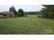 Large grassy backyard with mature trees offers a secluded and peaceful retreat at 711 Burtonwood Ln, Lincolnton, NC 28092