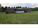 Spacious backyard featuring a screen porch and shed provides outdoor living at 711 Burtonwood Ln, Lincolnton, NC 28092