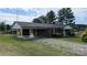 Relaxing brick home boasts a carport and a cozy front porch in a peaceful setting at 711 Burtonwood Ln, Lincolnton, NC 28092