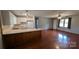 Open living space with hardwood floors flows into the kitchen area with bar seating at 711 Burtonwood Ln, Lincolnton, NC 28092