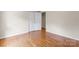 Bedroom showcases hardwood floors and a double-door closet and open closet at 8007 Caldwell Rd, Harrisburg, NC 28075