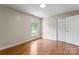 Bedroom with natural light from a window, hardwood floors and a closet at 8007 Caldwell Rd, Harrisburg, NC 28075
