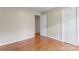 Bedroom featuring hardwood floors and a full closet at 8007 Caldwell Rd, Harrisburg, NC 28075