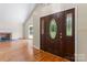 Elegant foyer featuring hardwood floors and a decorative front door at 8007 Caldwell Rd, Harrisburg, NC 28075